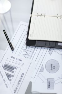 Notepad and business charts on desk
